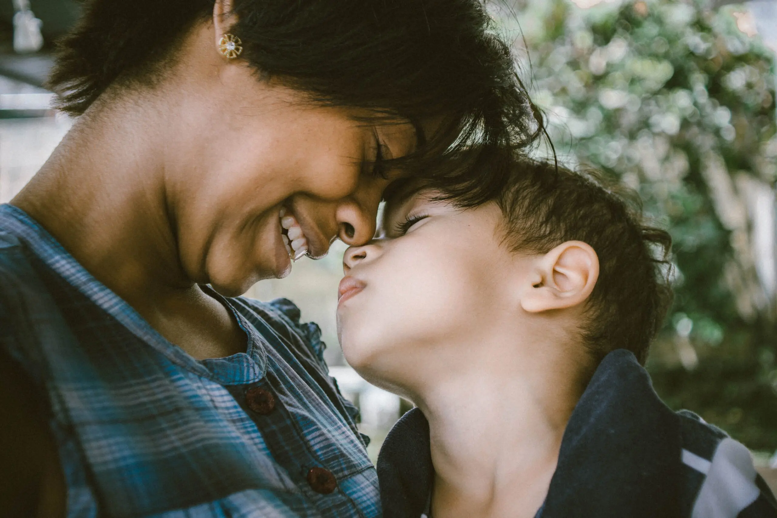 Parent and child touching noses and smiling