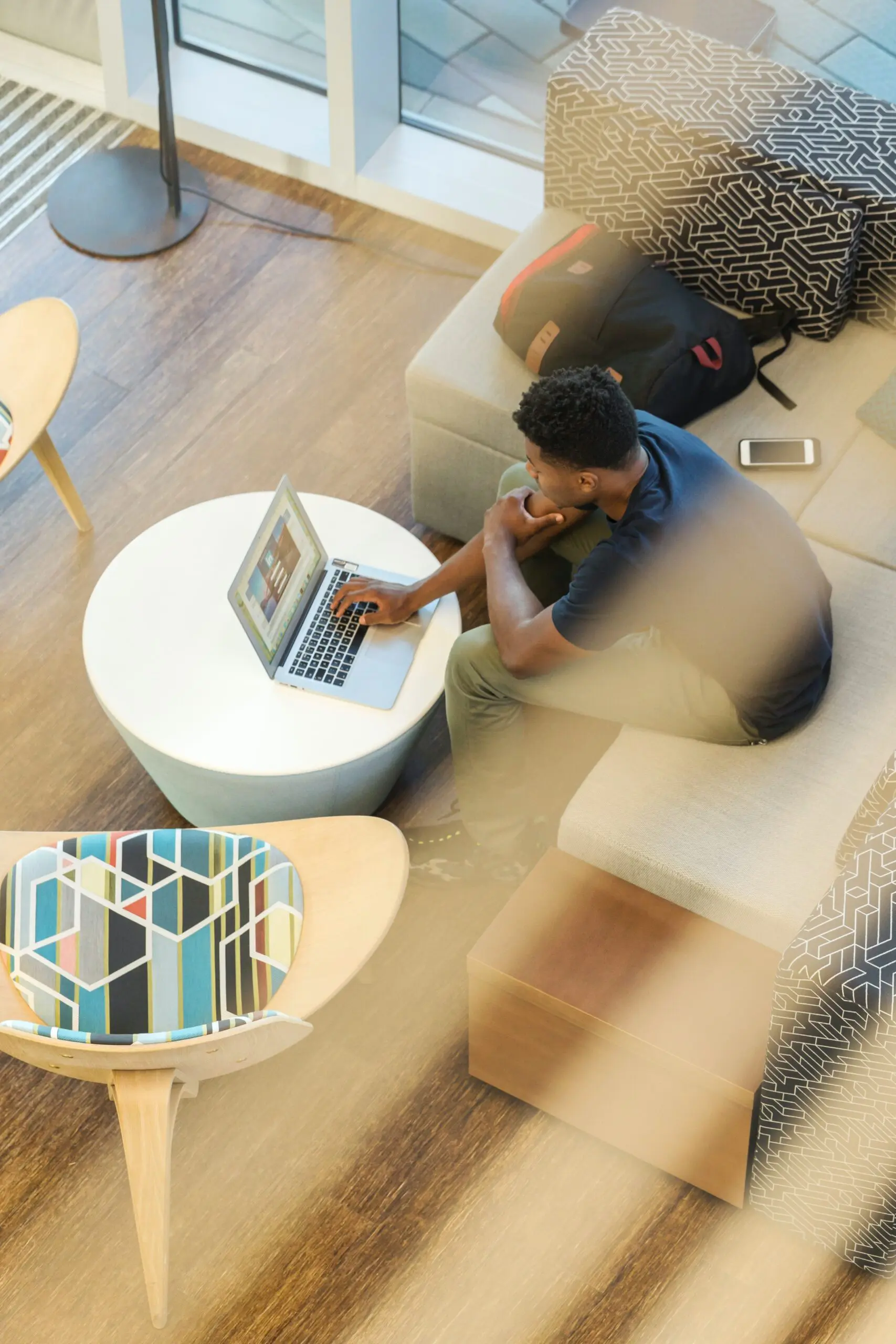 Overhead view of a small table and armchair in a sunny room